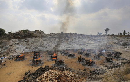 Funeral pyres of twenty-five COVID-19 victims burn at an open crematorium set up at a granite quarry on the outskirts of Bengaluru, India, Wednesday, May 5, 2021.