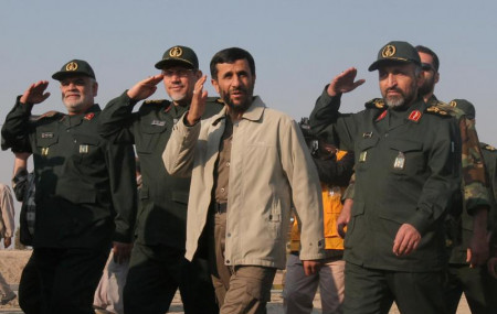 In this Nov. 26, 2006 file photo, then Iranian President Mahmoud Ahmadinejad, third left, reviews Basij paramilitary volunteers, affiliated to the elite Revolutionary Guard, at a parade ceremony in Tehran, Iran.