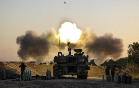 An Israeli artillery unit fires shells towards targets in Gaza Strip, at the Israeli Gaza border, Wednesday, May 19, 2021.