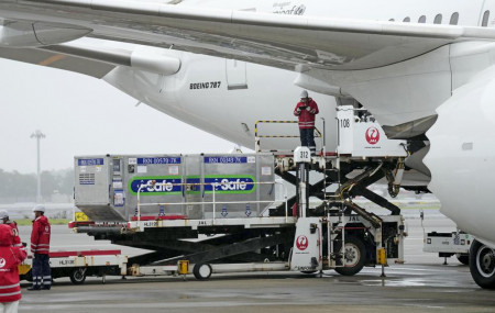 The containers carrying the coronavirus vaccines donated by Japanese government, are loaded to a plane before its departure for Taiwan, at Narita International Airport in Narita, east of Tokyo, Friday, June 4, 2021.