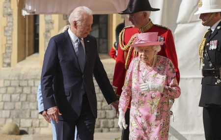 Britain's Queen Elizabeth II, right, walks with US President Joe Biden during his visit to Windsor Castle, near London, Sunday June 13, 2021.