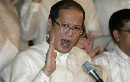 In this June 30, 2010, file photo, then newly inaugurated Philippine President Benigno Aquino III, center, swears in local officials during his first day at the Malacanang presidential palace in Manila, Philippines.