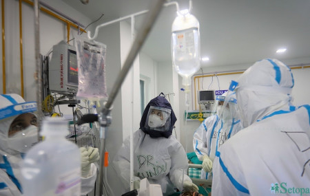 Dr Kundu Shrestha and fellow medics attending to a patient at the ICU ward.