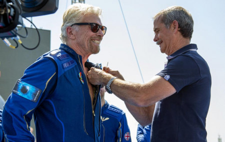 Virgin Galactic founder Richard Branson, left, receives a Virgin Galactic made astronaut wings pin from Canadian astronaut Chris Hadfield after his flight to space from Spaceport America near Truth or Consequences, New Mexico, Sunday