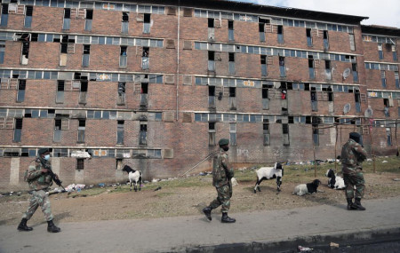 South African Defence Force soldiers on patrol alongside the male single sex hostels in Alexandra Township, north of Johannesburg, Thursday, July 15 2021.