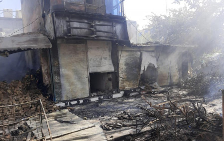 Smoke rises from damaged shops after fighting between Taliban and Afghan security forces in Kunduz city, northern Afghanistan, Sunday, Aug. 8, 2021.