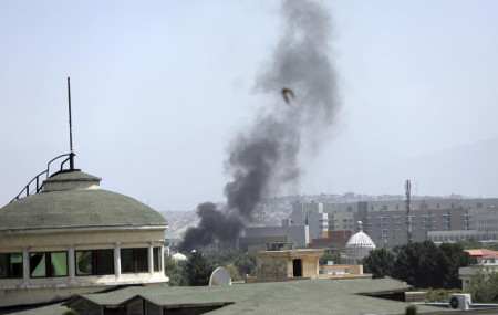 Smoke rises next to the U.S. Embassy in Kabul, Afghanistan, Sunday, Aug. 15, 2021.