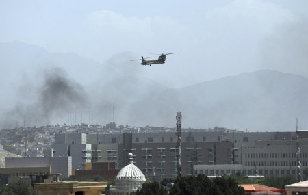 A U.S. Chinook helicopter flies over the city of Kabul, Afghanistan, Sunday, Aug. 15, 2021.