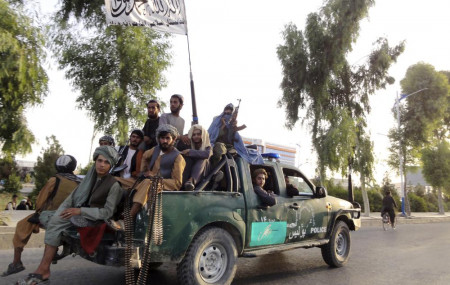 Taliban fighters patrol inside the city of Kandahar, southwest Afghanistan, Sunday, Aug. 15, 2021.