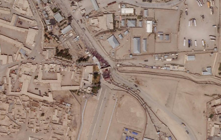 In this satellite photo taken by Planet Labs Inc., a massive crowd is seen at the gate marking the border crossing between Spin Boldak, Afghanistan, and Chaman, Pakistan, Thursday, Aug. 26, 2021.