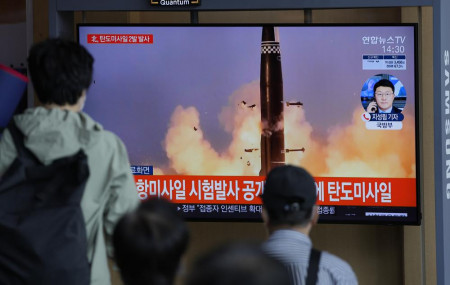 People watch a TV screen showing a news program reporting about North Korea's missiles with file image in Seoul, South Korea, Wednesday, Sept. 15, 2021.
