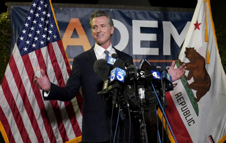California Gov. Gavin Newsom addresses reporters after beating back the recall attempt that aimed to remove him from office, at the John L. Burton California Democratic Party headquarters in Sacramento, California