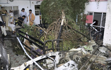 In this Sunday, Aug. 29, 2021 file photo, Afghans inspect damage of Ahmadi family house after U.S. drone strike in Kabul, Afghanistan.