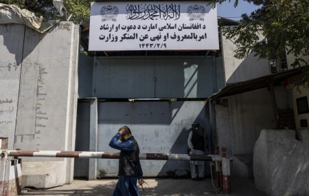 An Afghan man walks past the former Women's Affairs Ministry building in Kabul, Afghanistan, Saturday, Sept. 18, 2021.