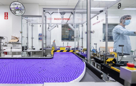 In this March 2021 photo provided by Pfizer, a technician works on a line for packaging preparation for the Pfizer-BioNTech COVID-19 vaccine at the company's facility in Puurs, Belgium.