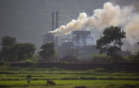 Smoke rises from a coal-powered steel plant at Hehal village near Ranchi, in eastern state of Jharkhand, Sunday, Sept. 26, 2021.