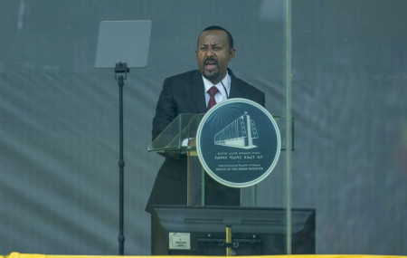 Ethiopia's Prime Minister Abiy Ahmed speaks behind bulletproof glass at his inauguration ceremony, after he was sworn in for a second five-year term, in the capital Addis Ababa, Ethiopia Monday, Oct. 4, 2021.