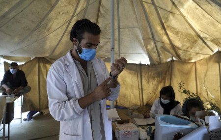 A doctor fills a syringe with the Johnson & Johnson COVID-19 vaccine donated through the U.N.-backed COVAX program at a vaccination center in Kabul, Afghanistan, Sunday, July 11, 2021.