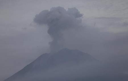 Mount Semeru releases volcanic materials during an eruption as seen from Lumajang, East Java, Indonesia, Sunday, Dec. 5, 2021.