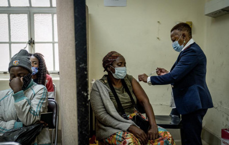 A woman is vaccinated against COVID-19 at the Hillbrow Clinic in Johannesburg, South Africa, Monday Dec. 6, 2021.