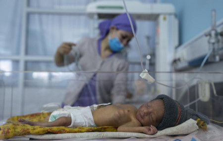 A nurse takes care of a baby in the neonatal intensive care unit of Malalai Maternity hospital in Kabul Afghanistan, on Thursday, Dec. 9, 2021.