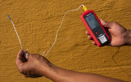 Vivek Shandas, a professor of climate adaptation at Portland State University, takes a temperature reading of almost 106 degrees in downtown Portland, Oregon, on Aug. 12, 2021.