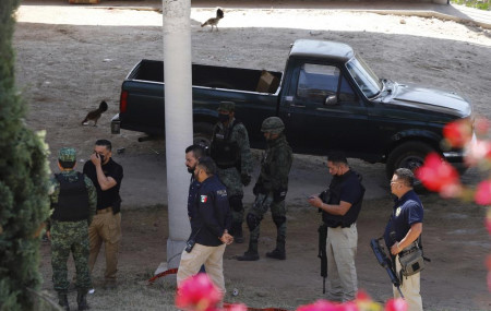 Army officers and Michoacan state prosecutors inspect the cockfighting site 