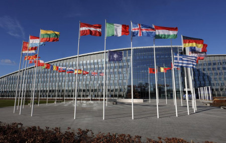 Flags flutter in the wind outside NATO headquarters in Brussels, Feb. 7, 2022.
