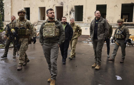 In this photo provided by the Ukrainian Presidential Press Office on Sunday, May 29, 2022, Ukrainian President Volodymyr Zelenskyy walks with his stuff as he visits the war-hit Kharkiv region.