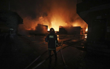 A firefighter works to contain a fire that broke out at the BM Inland Container Depot, a Dutch-Bangladesh joint venture, in Chittagong, 216 km southeast of capital, Dhaka, Bangladesh, early Sunday, June 5. (AP Photo)