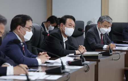 In this photo provided by South Korea Presidential Office, South Korean President Yoon Suk Yeol, center, attends at the National Security Council (NSC) meeting at the presidential office in Seoul, South Korea, Sunday, June 5, 2022.