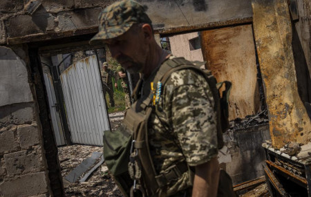 FILE - Commander of an artillery unit of the Ukrainian army, Mykhailo Strebizh, center, inside a destroyed house due to shelling in a village near the frontline in the Donetsk oblast region, eastern Ukraine, Thursday, June 2, 2022. AP/RSS Photo