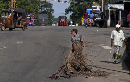 A man pulls fallen coconut leaves to be used as firewood amid shortage of cooking gas along a usually congested road in Colombo, Sri Lanka, Thursday, June 23, 2022. AP/RSS Photo