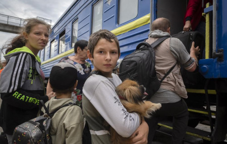 A boy holds his pet dog as his family evacuated from the war-hit area gets on an evacuation train in Pokrovsk, eastern Ukraine, Saturday , June 25, 2022. AP/RSS Photo