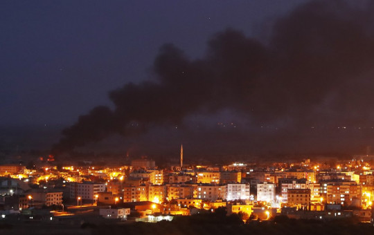 In this photo taken from the Turkish side of the border between Turkey and Syria, in Ceylanpinar, Sanliurfa province, southeastern Turkey, smoke billows from fires in Ras al-Ayn, Syria, caused by bombardment by Turkish forces, Wednesday, Oct. 16, 2019.