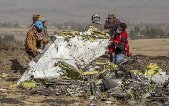 In this file photo dated Monday, March 11, 2019, rescuers work at the scene of an Ethiopian Airlines plane crash south of Addis Ababa, Ethiopia.