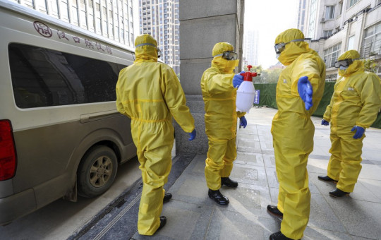 File Photo of health workers disinfecting themselves in China.