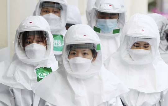 Medical staff members arrive for a duty shift at Dongsan Medical Center in Daegu, South Korea, Monday, March 30, 2020.