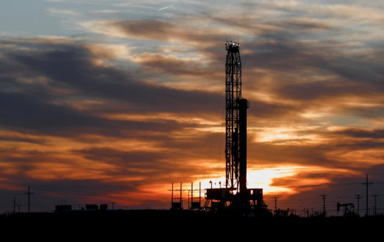 An oil rig stands against the setting sun in Midland, Texas on Friday, April 17, 2020.
