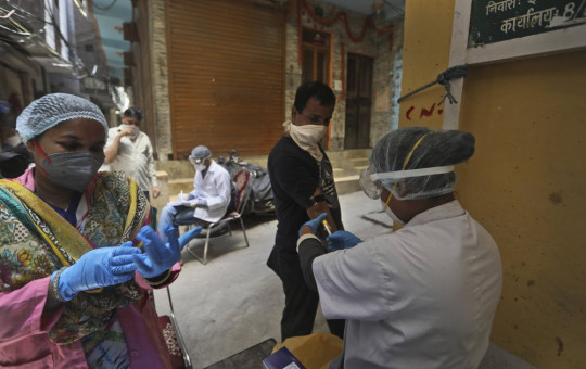 Health workers take blood samples for a random serological test to check for antibodies against the coronavirus in New Delhi, India, Thursday, Aug. 6, 2020.