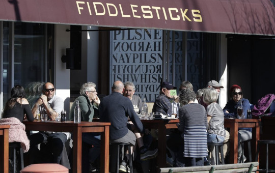 Customers at a cafe enjoy lunch in the sunshine in Christchurch, New Zealand, Sunday, Aug. 9, 2020. New Zealand marked a 100 days of being free from the coronavirus in its communities Sunday.