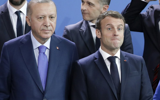 In this Sunday, Jan. 20, 2020 file photo, Turkey's President Recep Tayyip Erdogan, left and French President Emmanuel Macron stand, during a group photo at a conference on Libya at the chancellery in Berlin, Germany.