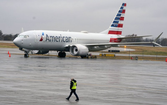 In this Dec. 2, 2020 file photo, an American Airlines Boeing 737 Max jet plane is parked at a maintenance facility in Tulsa, Oklahoma.