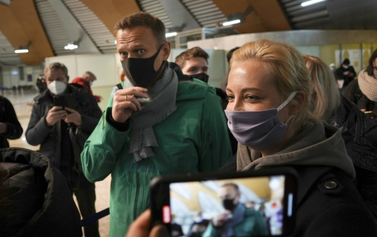 Alexei Navalny and his wife Yuliastand in line at the passport control after arriving at Sheremetyevo airport, outside Moscow, Russia, Sunday, Jan. 17, 2021.