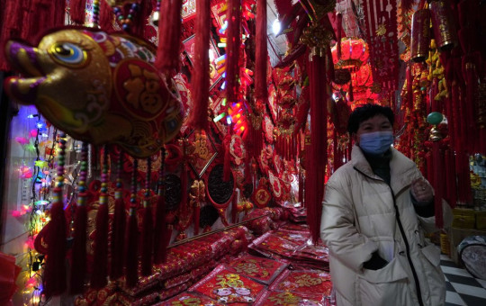 Gong Linhua, a seller of Lunar New Year decorations, speaks about the impact of the coronavirus on her business ahead of the Year of the Ox Chinese Lunar New Year celebrations in Wuhan in central China's Hubei province on Tuesday.