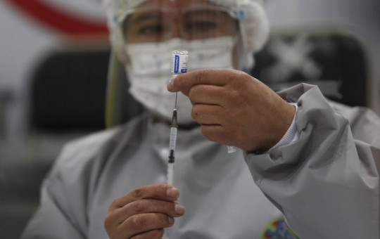 A healthcare worker prepares a dose of Russia's Sputnik V COVID-19 vaccine, at the Del Norte Hospital in El Alto, Bolivia, Saturday, Jan. 30, 2021.