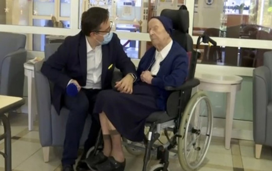 In this image made from BFM TV video, Sister Andre, born Lucile Randon, is interviewed by David Tavella, Communications Manager for the Sainte Catherine Laboure Nursing Home in Toulon, France, Tuesday Feb. 9, 2021.