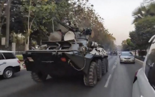 In this image made from video by the Democratic Voice of Burma (DVB), two armored personnel carriers were seen traversing on a road in Yangon, Myanmar, Sunday, Feb. 14, 2021.