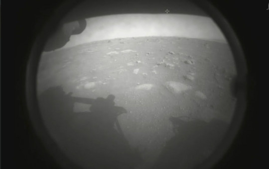 This photo made available by NASA shows the first image sent by the Perseverance rover showing the surface of Mars, just after landing in the Jezero crater, on Thursday, Feb. 18, 2021.