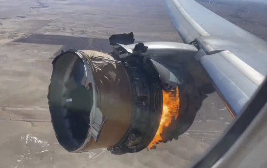 In this image taken from video, the engine of United Airlines Flight 328 is on fire after after experiencing